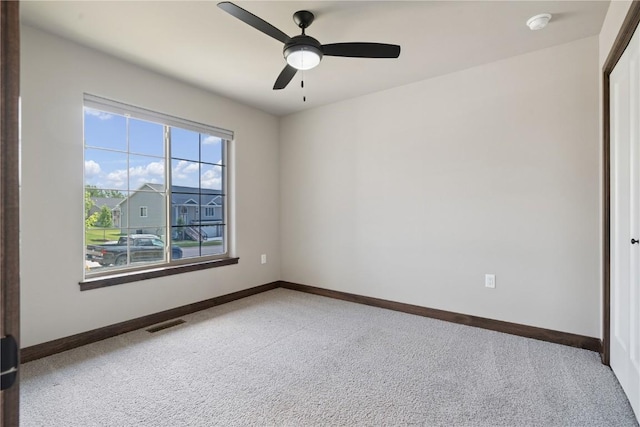 713 Hillside Dr, Tiffin, IA 52340 - unfurnished room featuring carpet flooring and a ceiling fan