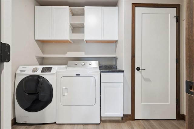 713 Hillside Dr, Tiffin, IA 52340 - washroom with independent washer and dryer, cabinet space, and light wood-type flooring