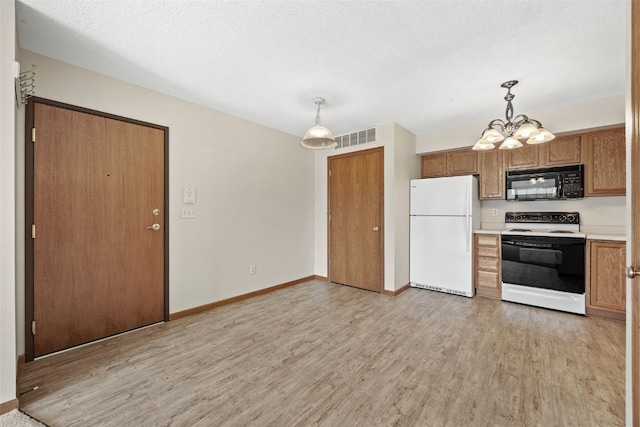 3120 Wilson Ave SW Unit 2, Cedar Rapids, IA 52404 - kitchen with white appliances, light wood-type flooring, a chandelier, light countertops, and decorative light fixtures