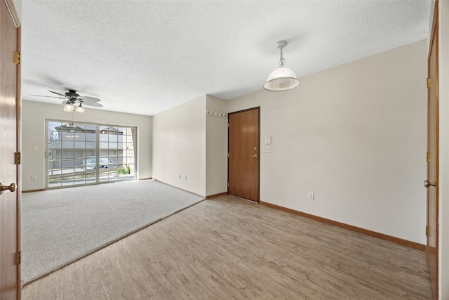 3120 Wilson Ave SW Unit 2, Cedar Rapids, IA 52404 - spare room with a textured ceiling, wood finished floors, and ceiling fan