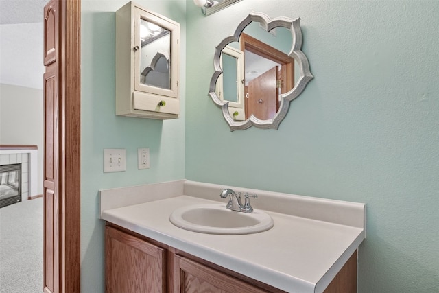 3120 Wilson Ave SW Unit 2, Cedar Rapids, IA 52404 - bathroom featuring vanity and a tile fireplace