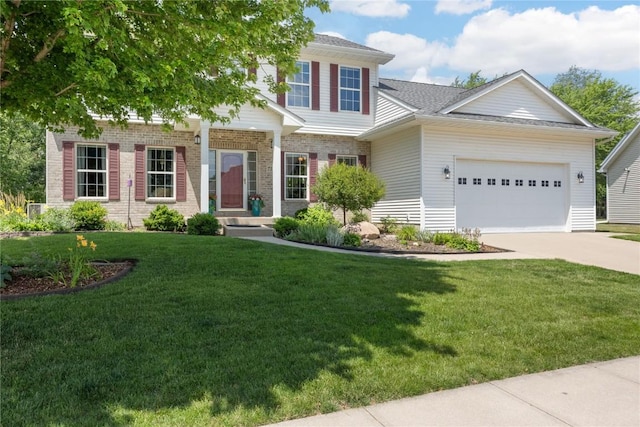 712 Willow Ct, Solon, IA 52333 - view of front of house featuring a garage, driveway, a front yard, and brick siding