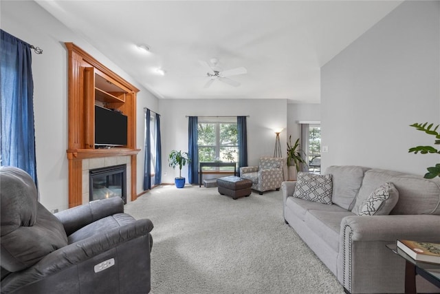 712 Willow Ct, Solon, IA 52333 - living area featuring carpet, a ceiling fan, and a tile fireplace