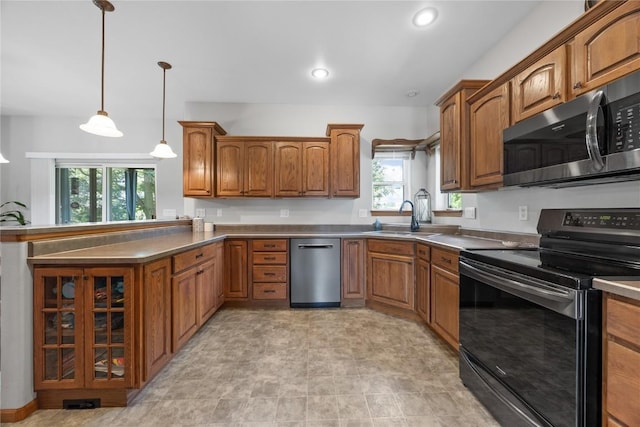 712 Willow Ct, Solon, IA 52333 - kitchen with appliances with stainless steel finishes, brown cabinets, a peninsula, pendant lighting, and recessed lighting