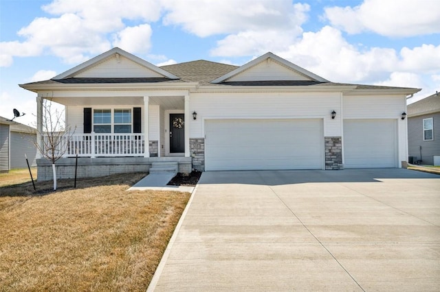 305 Sumac Dr, Palo, IA 52324 - view of front facade with an attached garage, covered porch, driveway, a front lawn, and stone siding