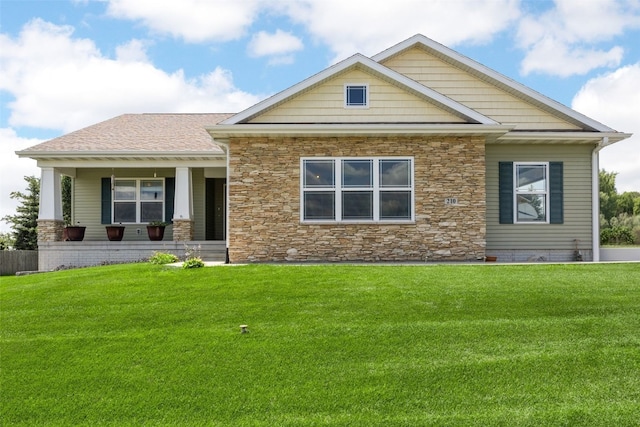 210 Northgate St NW, Shellsburg, IA 52332 - craftsman-style house featuring stone siding, a front lawn, and a porch
