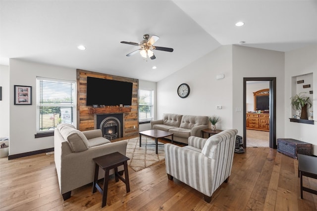 210 Northgate St NW, Shellsburg, IA 52332 - living room featuring a ceiling fan, healthy amount of natural light, hardwood / wood-style floors, vaulted ceiling, and a large fireplace