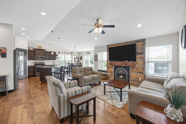 210 Northgate St NW, Shellsburg, IA 52332 - living room with lofted ceiling, ceiling fan, light wood finished floors, a large fireplace, and recessed lighting