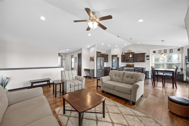 210 Northgate St NW, Shellsburg, IA 52332 - living room featuring lofted ceiling, a ceiling fan, wood finished floors, and recessed lighting