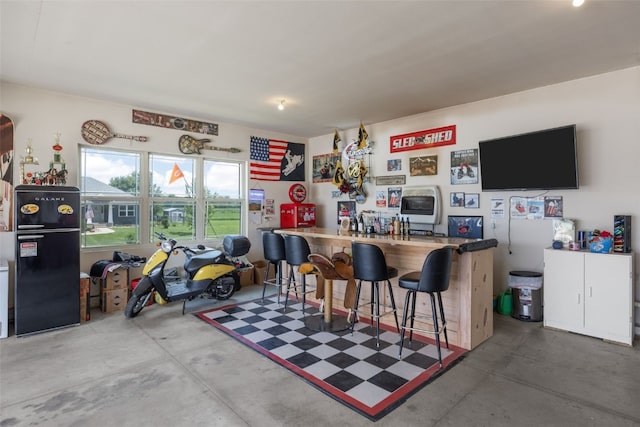 210 Northgate St NW, Shellsburg, IA 52332 - indoor dry bar featuring concrete floors and freestanding refrigerator