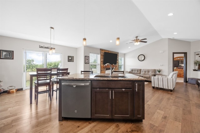 210 Northgate St NW, Shellsburg, IA 52332 - kitchen with stainless steel dishwasher, dark brown cabinets, light stone counters, light wood-type flooring, and vaulted ceiling