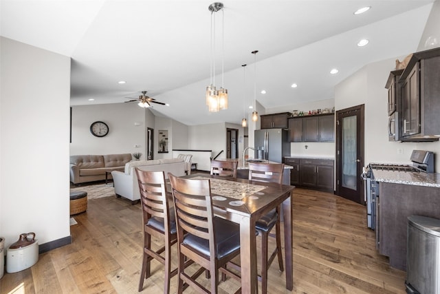 210 Northgate St NW, Shellsburg, IA 52332 - dining area with lofted ceiling, wood finished floors, a ceiling fan, and recessed lighting