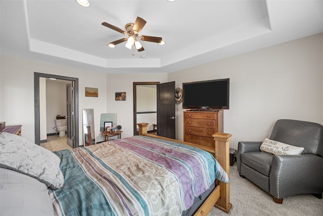 210 Northgate St NW, Shellsburg, IA 52332 - bedroom with a raised ceiling, recessed lighting, connected bathroom, a ceiling fan, and light carpet