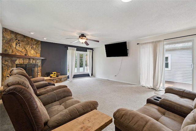 3642 Redbud Rd NE, Cedar Rapids, IA 52402 - carpeted living area with a ceiling fan, a fireplace, and a textured ceiling