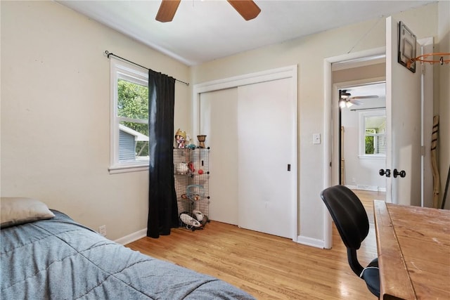 3642 Redbud Rd NE, Cedar Rapids, IA 52402 - bedroom with light wood-style flooring, a closet, and a ceiling fan