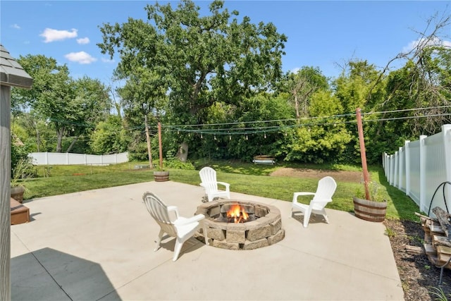 3642 Redbud Rd NE, Cedar Rapids, IA 52402 - fenced backyard with a fire pit, a patio area, and view of wooded area