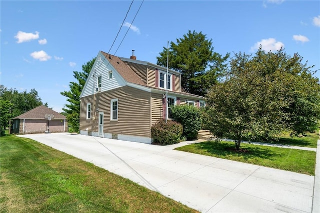1207 E 4th St, Vinton, IA 52349 - view of side of home with a lawn and a chimney