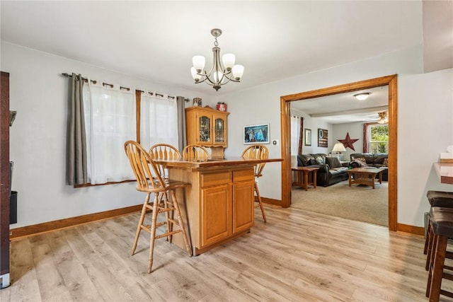 1207 E 4th St, Vinton, IA 52349 - dining area with a chandelier and light wood finished floors
