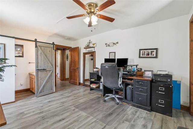 1207 E 4th St, Vinton, IA 52349 - office space with a ceiling fan, light wood finished floors, and a barn door