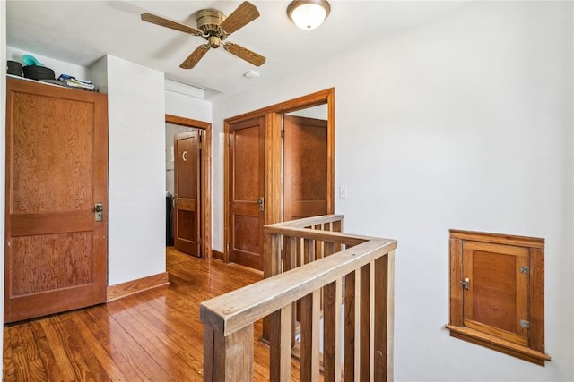 1207 E 4th St, Vinton, IA 52349 - corridor featuring wood finished floors and an upstairs landing