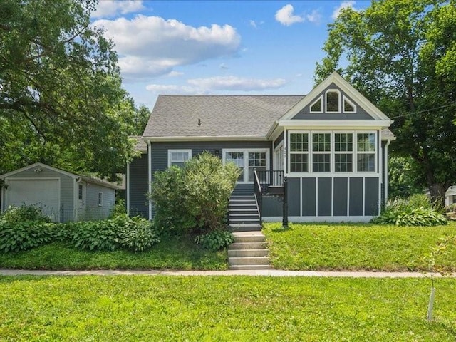 425 24th NE, Cedar Rapids, IA 52402 - back of property with a yard, a detached garage, an outbuilding, and stairway
