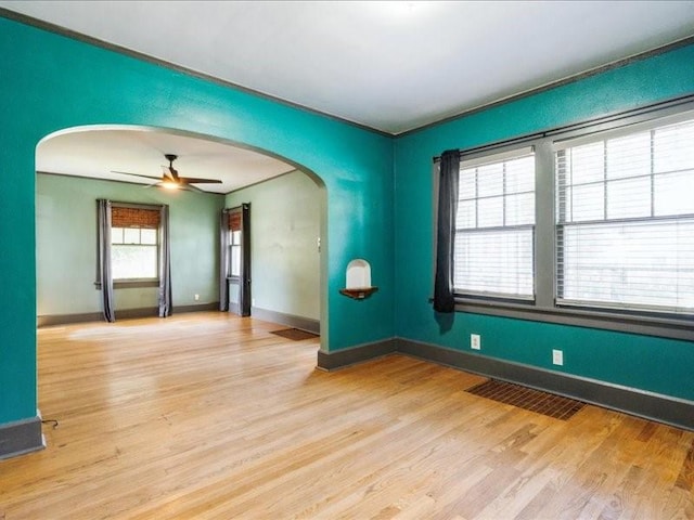 425 24th NE, Cedar Rapids, IA 52402 - empty room with arched walkways, wood finished floors, and ceiling fan