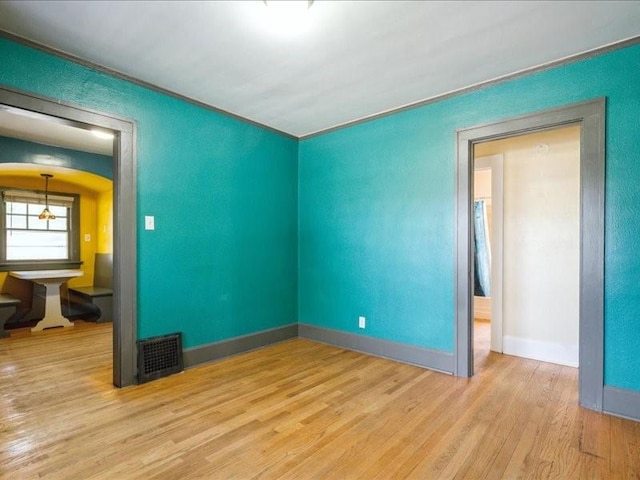 425 24th NE, Cedar Rapids, IA 52402 - spare room featuring wood finished floors and arched walkways