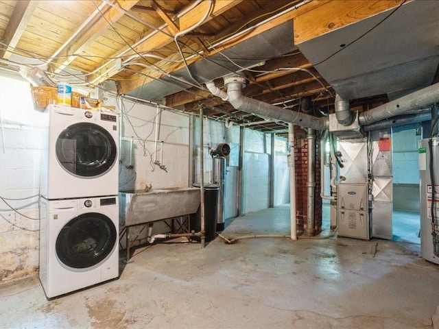 425 24th NE, Cedar Rapids, IA 52402 - unfinished basement featuring stacked washer / drying machine, heating unit, and gas water heater