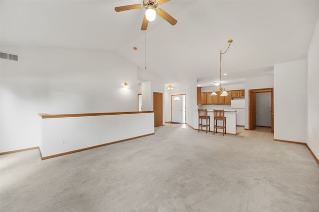 819 Winterberry Pl NE, Cedar Rapids, IA 52402 - unfurnished living room with ceiling fan, light colored carpet, and vaulted ceiling