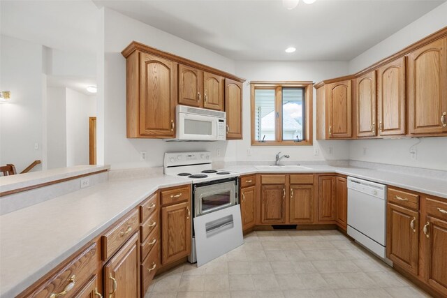 819 Winterberry Pl NE, Cedar Rapids, IA 52402 - kitchen featuring white appliances, brown cabinets, and light countertops