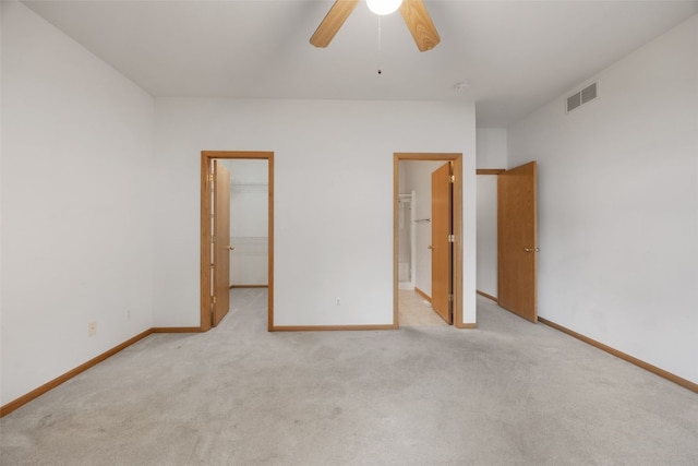 819 Winterberry Pl NE, Cedar Rapids, IA 52402 - unfurnished bedroom featuring a walk in closet, carpet floors, a closet, ceiling fan, and ensuite bathroom