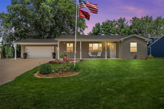 330 E S St, Lisbon, IA 52253 - ranch-style house featuring covered porch, a garage, a yard, and concrete driveway