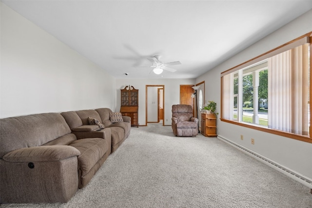 330 E S St, Lisbon, IA 52253 - living area with light carpet, ceiling fan, and a baseboard heating unit