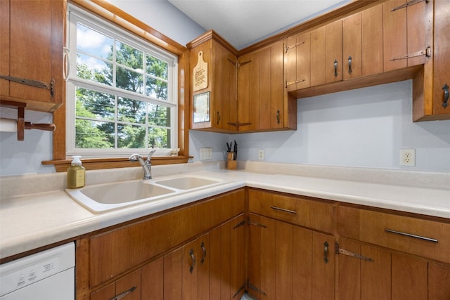 330 E S St, Lisbon, IA 52253 - kitchen featuring dishwasher, light countertops, and brown cabinets