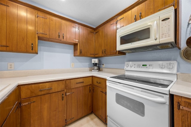 330 E S St, Lisbon, IA 52253 - kitchen with white appliances, brown cabinets, and light countertops