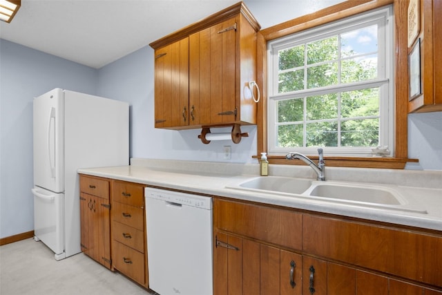 330 E S St, Lisbon, IA 52253 - kitchen featuring white appliances, light countertops, and brown cabinetry