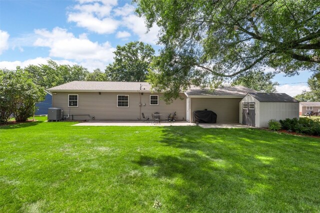 330 E S St, Lisbon, IA 52253 - rear view of house featuring a patio, a shed, and a lawn
