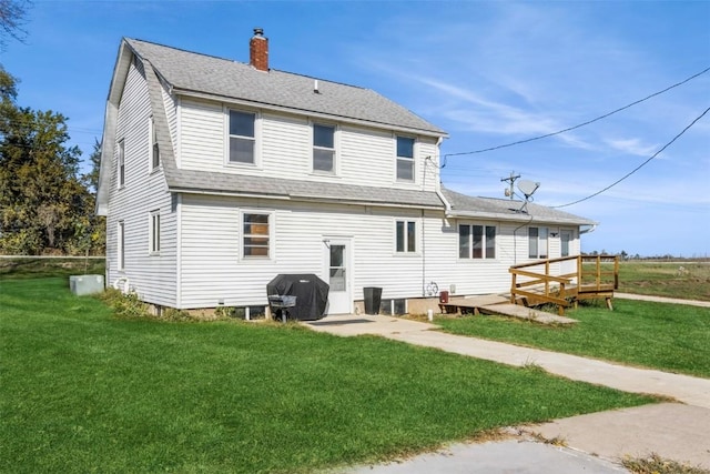 4100 Greens Grove Rd, Center Point, IA 52213 - back of house with a chimney, a yard, a wooden deck, and a shingled roof
