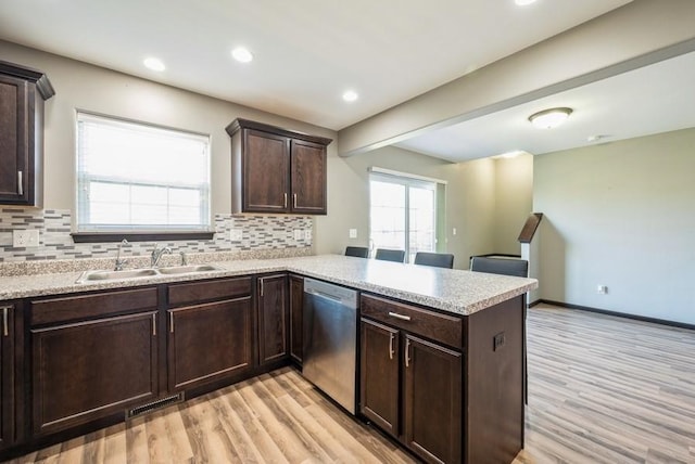 3212 Sherwood Pl, Marion, IA 52302 - kitchen featuring dishwasher, a peninsula, light wood-style flooring, tasteful backsplash, and recessed lighting