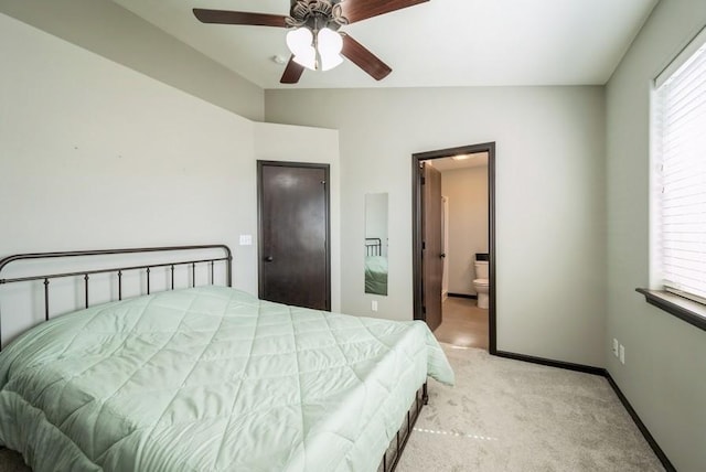 3212 Sherwood Pl, Marion, IA 52302 - carpeted bedroom with vaulted ceiling, ensuite bath, and a ceiling fan