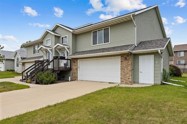 609 W Orange St, West Branch, IA 52358 - multi unit property with a garage, a front lawn, and concrete driveway