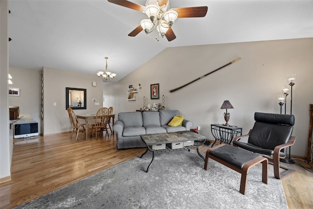 609 W Orange St, West Branch, IA 52358 - living room with wood finished floors, ceiling fan, lofted ceiling, and a chandelier