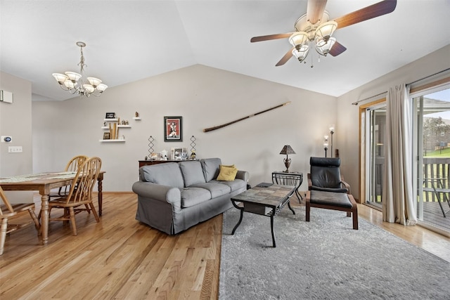 609 W Orange St, West Branch, IA 52358 - living room featuring vaulted ceiling, light wood finished floors, ceiling fan, and a chandelier