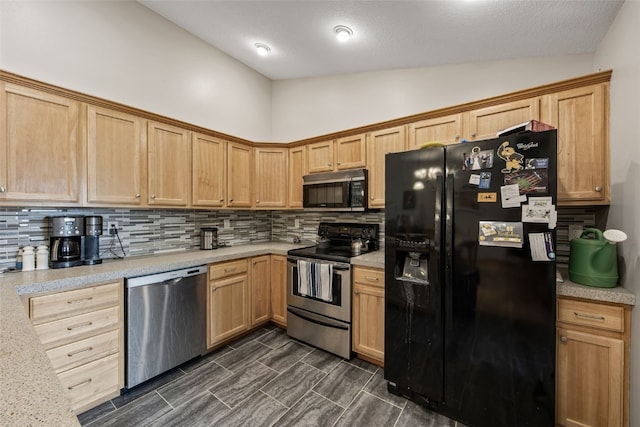 609 W Orange St, West Branch, IA 52358 - kitchen with stainless steel appliances, backsplash, light countertops, and lofted ceiling