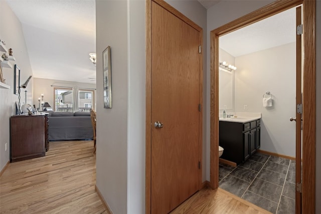609 W Orange St, West Branch, IA 52358 - hall featuring baseboards and light wood-style floors