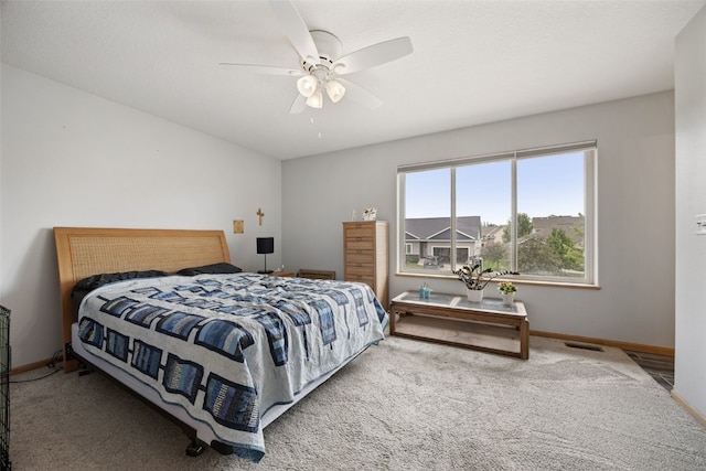 609 W Orange St, West Branch, IA 52358 - carpeted bedroom with baseboards and ceiling fan