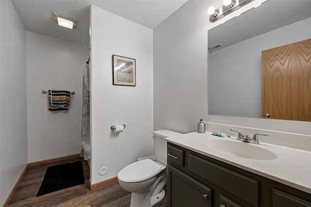609 W Orange St, West Branch, IA 52358 - bathroom with wood finished floors, vanity, and a shower with curtain