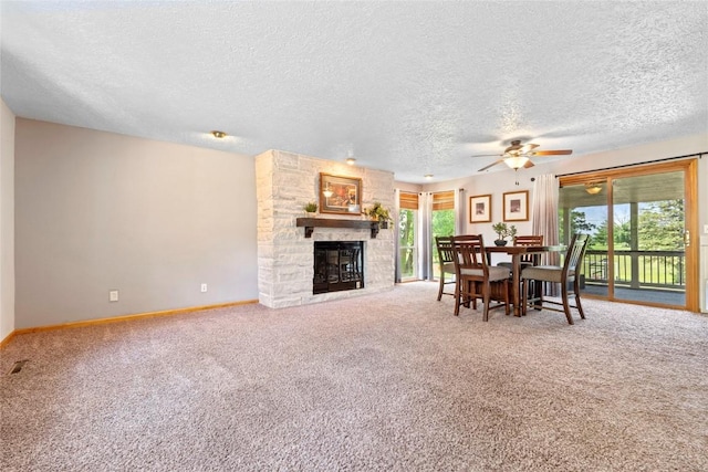 101 Golf Cir, Winfield, IA 52659 - carpeted dining area with a textured ceiling, a ceiling fan, and a stone fireplace