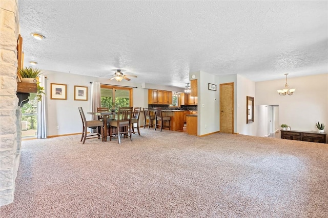 101 Golf Cir, Winfield, IA 52659 - dining room featuring ceiling fan, a textured ceiling, a chandelier, and light colored carpet