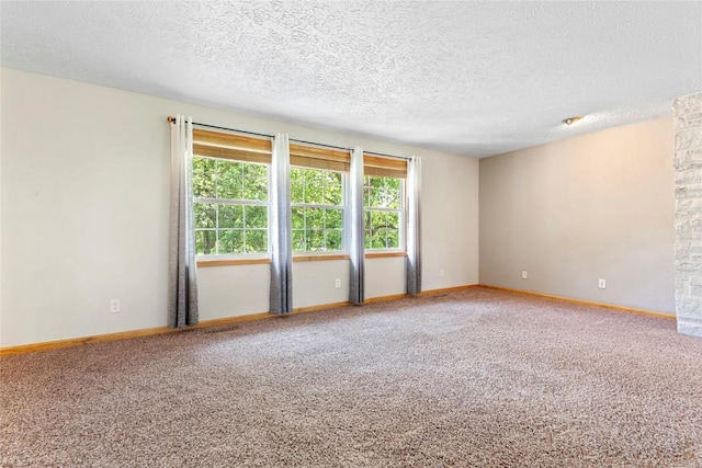 101 Golf Cir, Winfield, IA 52659 - carpeted empty room featuring a textured ceiling and baseboards